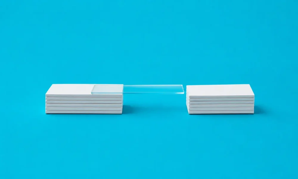 Illustration de deux petites plateformes blanches minimalistes avec une seule plaque transparente en plexiglas posée à côté sans relier les deux.